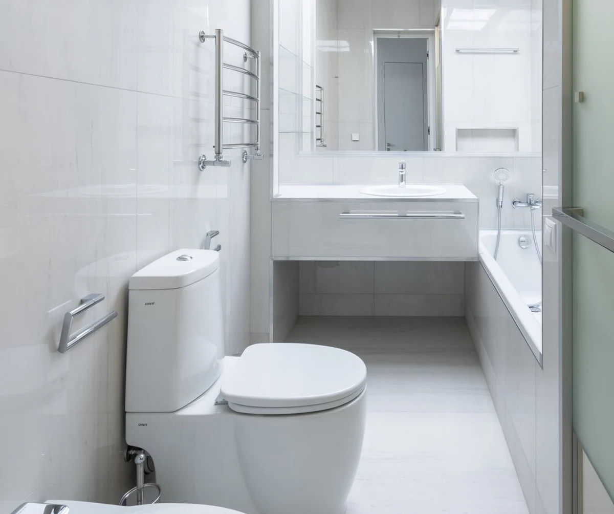 White porcelain floor-mounted toilet with a conventional tank and bowl in a clean residential bathroom
